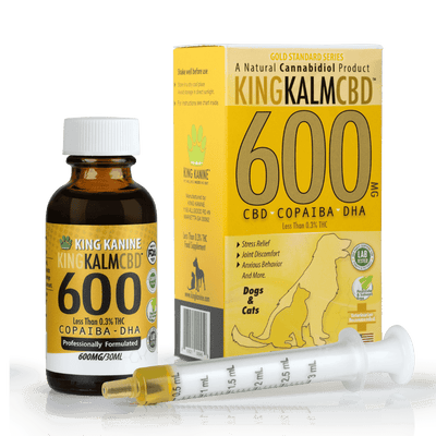 KING KALM 600mg CBD oil for dogs and cats, featuring a brown bottle, yellow box, and a dosing syringe.